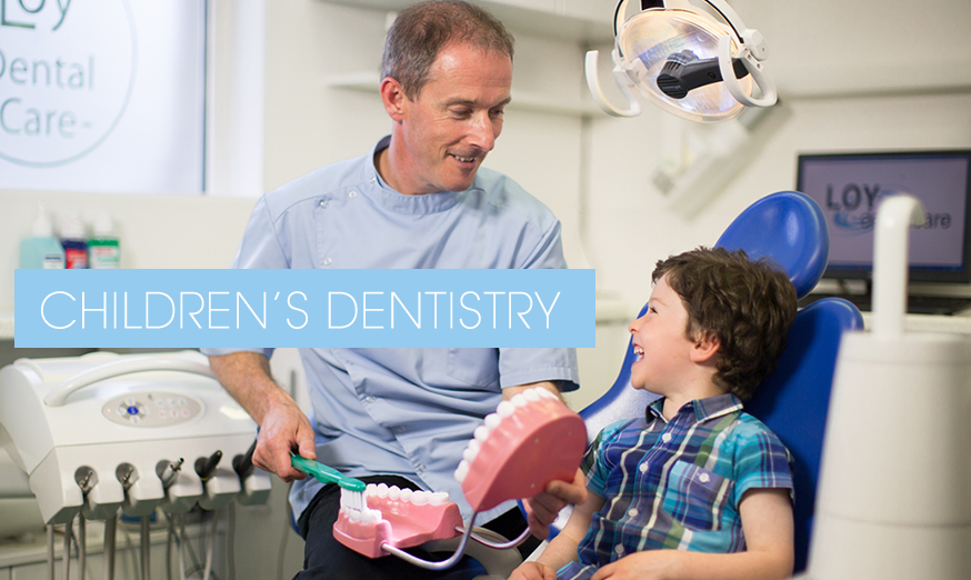 Loy dental Care's Paul demonstrating tooth brushing to a child