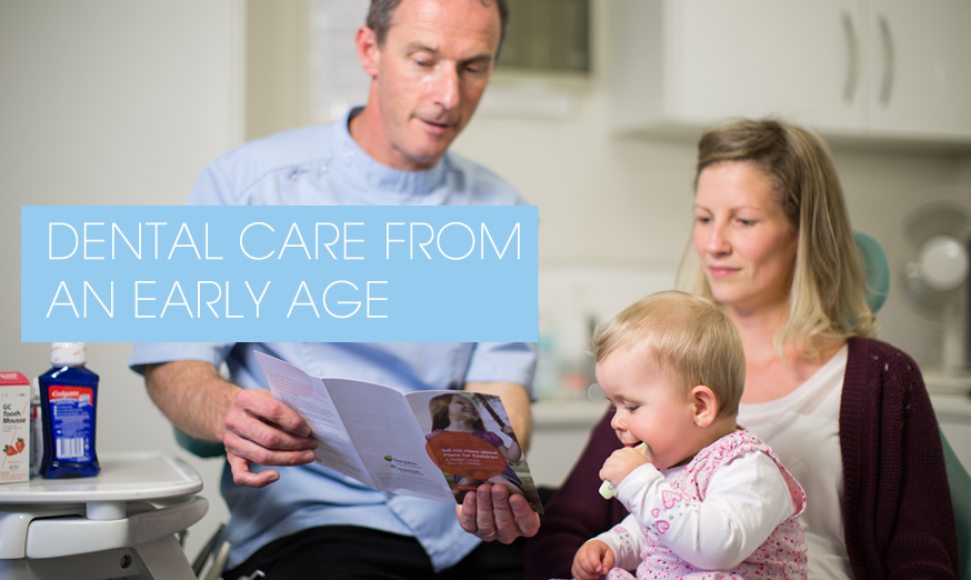 Paul Warwick discussing Dental care with mother and baby