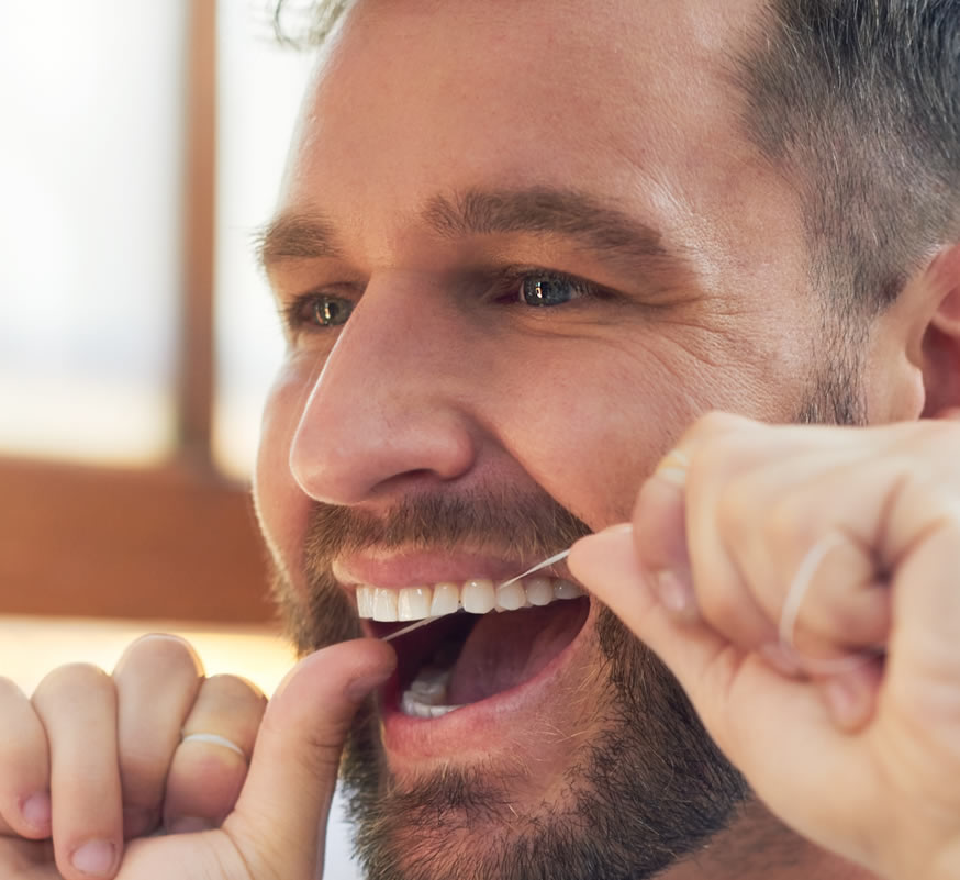 man flossing to treat gum disease