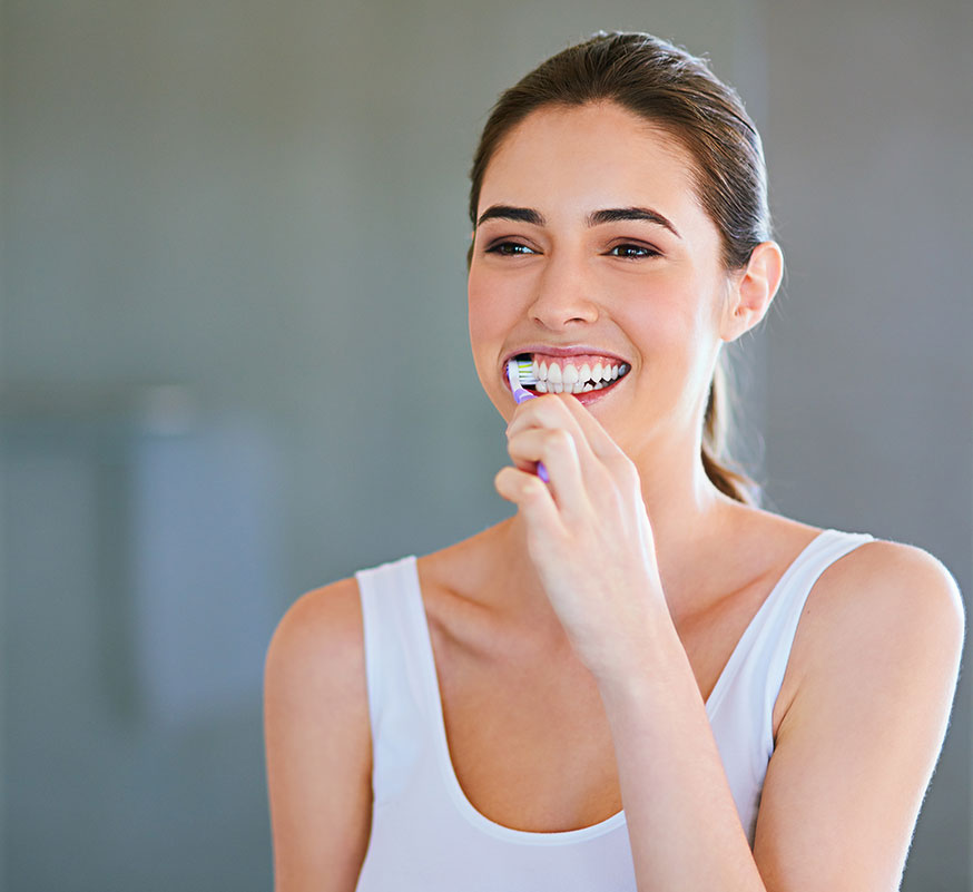 woman brushing her teeth